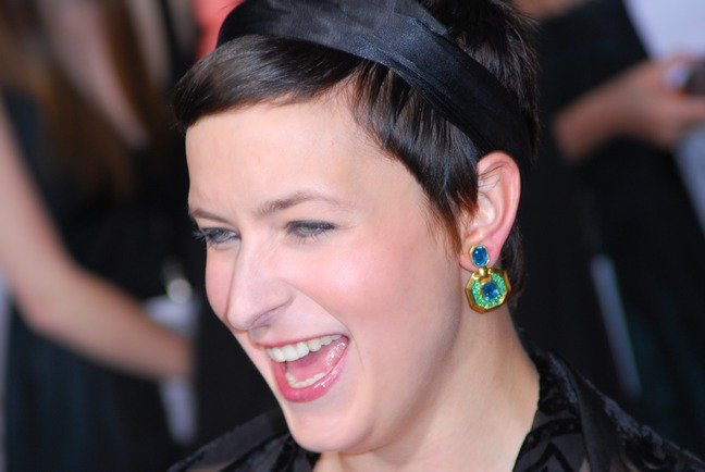 Diablo Cody, black silk headband, green and blue earrings, black top