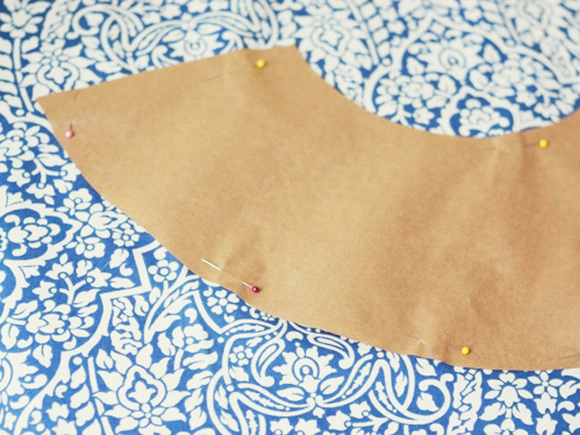 pinning the paisley print fabric on to the lamp shade