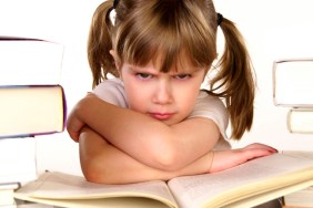 child scowling at homework
