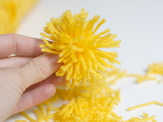a completed yellow diy pom pom