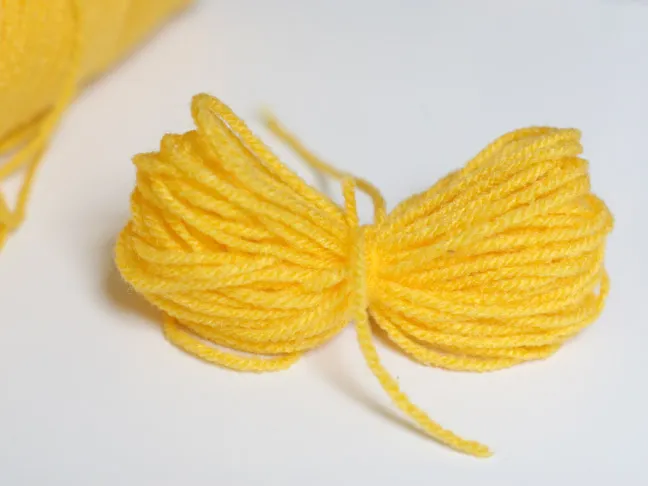 making a yellow pompom
