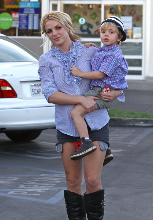 Britney Spears, blue shirt, jean shorts, black boots