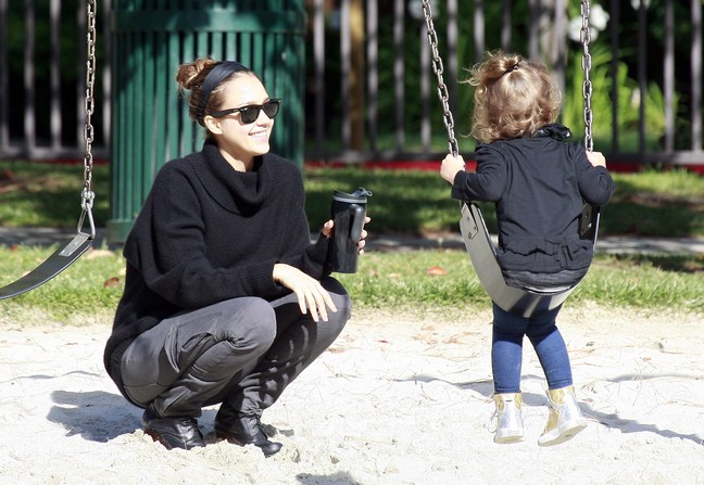 Jessica Alba wearing gray pants and a black sweater with a black headband, Jessica alba plays at park with honor marie