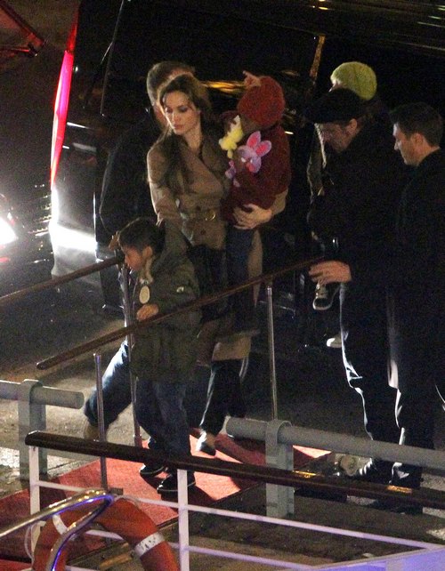Angelina Jolie and family in Paris for Pax's birthday wearing winter gear, tan coat, hat
