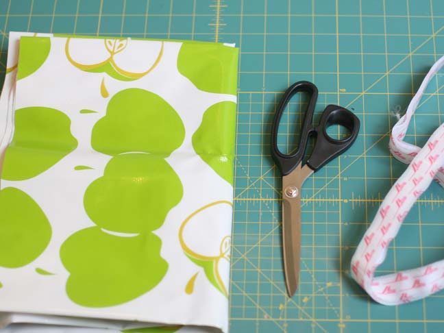 green apple oilcloth scissors on cutting mat