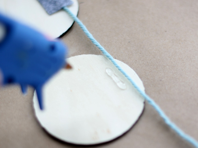 hot gluing yarn to a wood disk