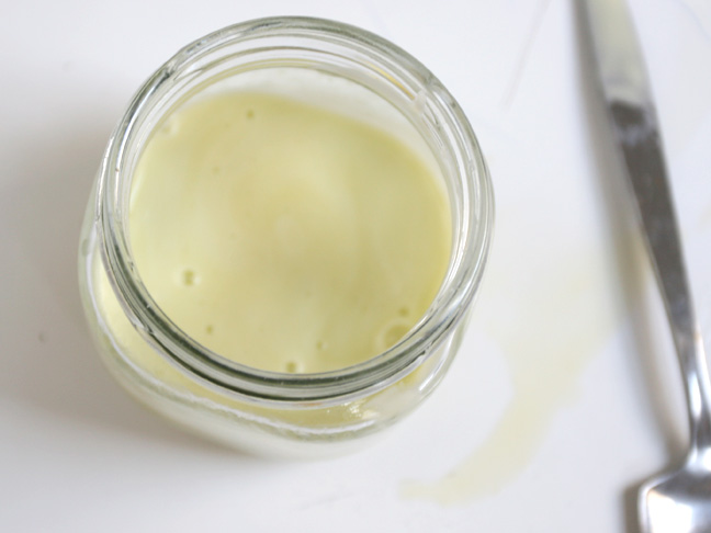 pale yellow liquid glass jar