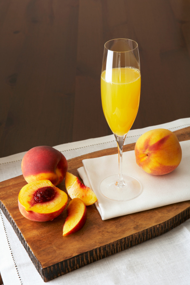 A peach bellini in a champagne glass