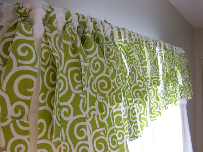 Window valance made with alternating strips of white and green spiral fabric