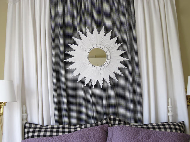 white starburst mirror over bed