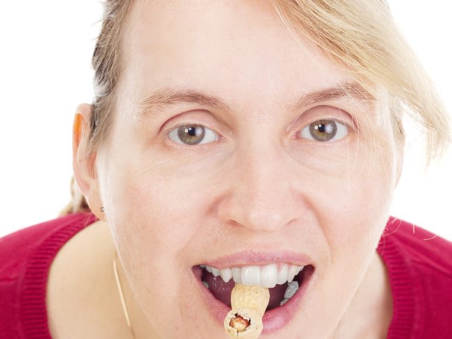 Woman eating peanut