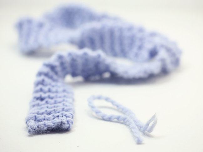 Adding a tassel to a knitted ribbon