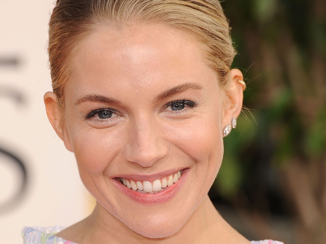 Sienna Miller with natural makeup and hair swept back