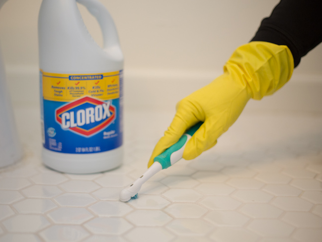 clorox-bleach-bathroom-tile-toothbrush-glove-hand