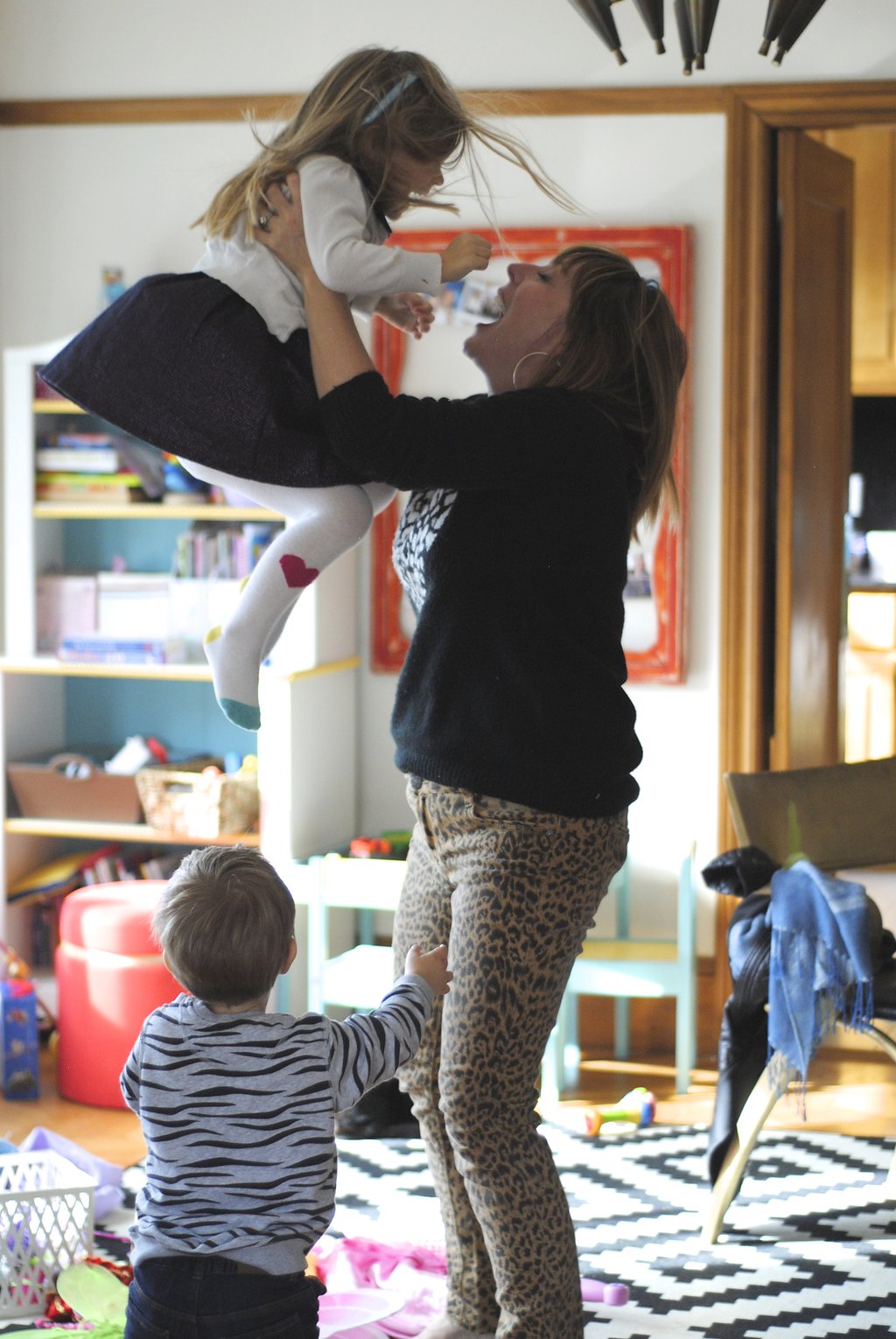 mom throwing kids in air and playing