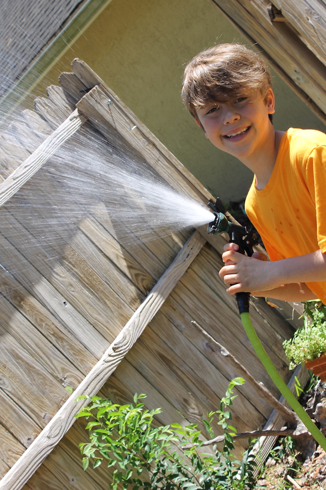 boy spraying a hose