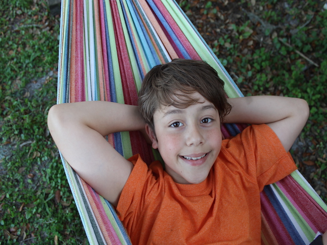 boy laying in hammock
