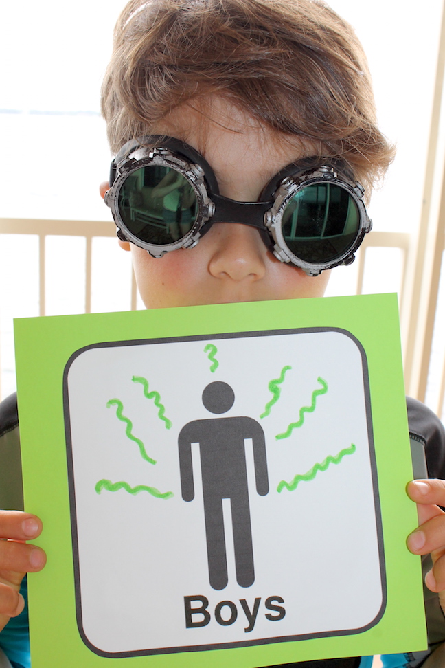 smelly boy bathroom sign with boy with goggles on