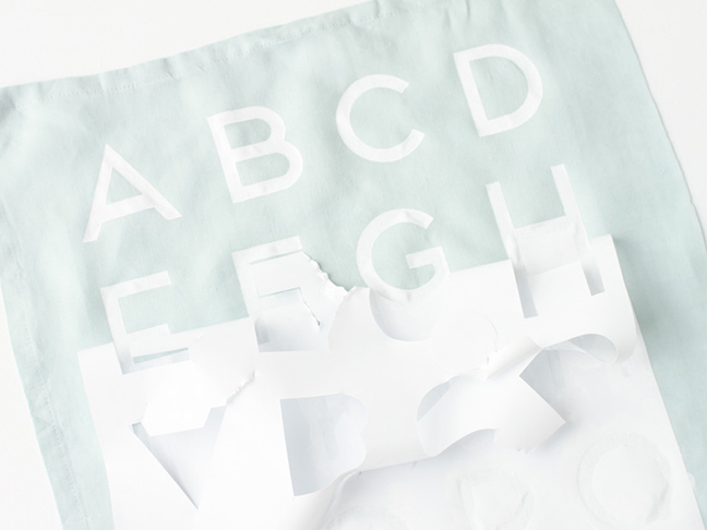Remove stencil to reveal the finished alphabet tea towel.
