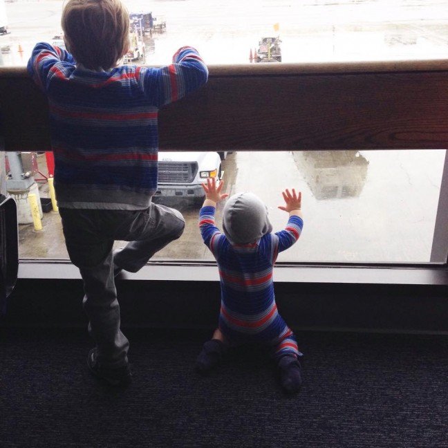 two kids watching planes airport