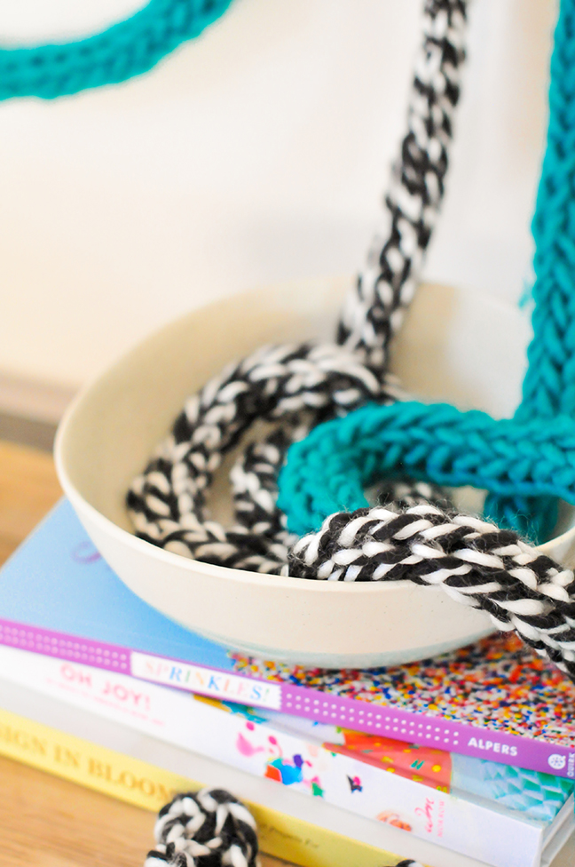 DIY Fingerknit Garlands styled on a wall