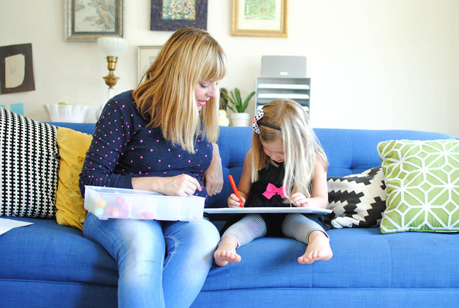 mom and daughter drawing on couch