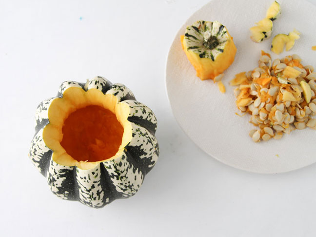Remove the seeds from a small pumpkin