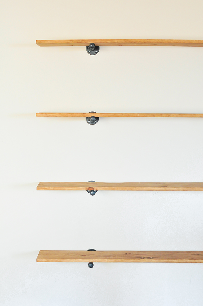 hanging plumbing supplies to create industrial wall shelves