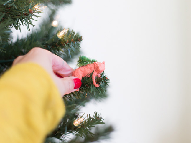 hand-decorating-christmas-tree-animal-ornament