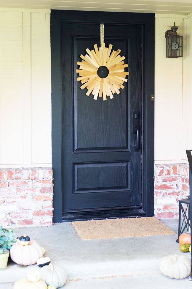 wood-starburst-wreath-on-black-door