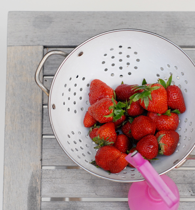 strawberries in white strainer