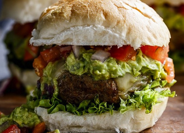 burger with guacamole and tomatoes