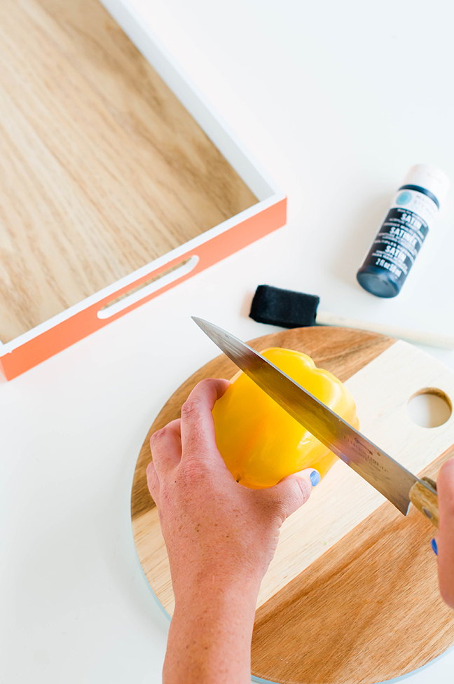 cutting yellow bell pepper wood cutting board