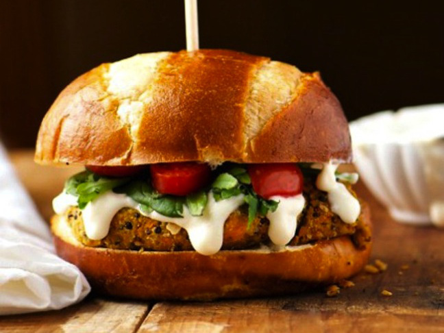 veggie burger with green and white sauce