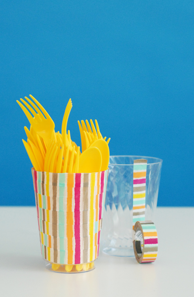 yellow plastic utensils in washi tape cup
