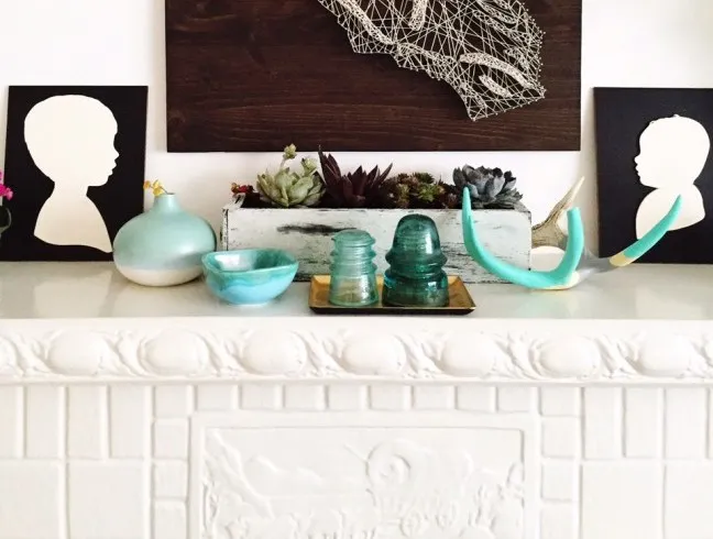 mantle decor with succulent garden and silhouettes