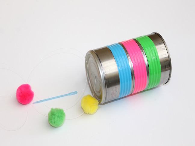 tin can wrapped in duct tape with pom poms