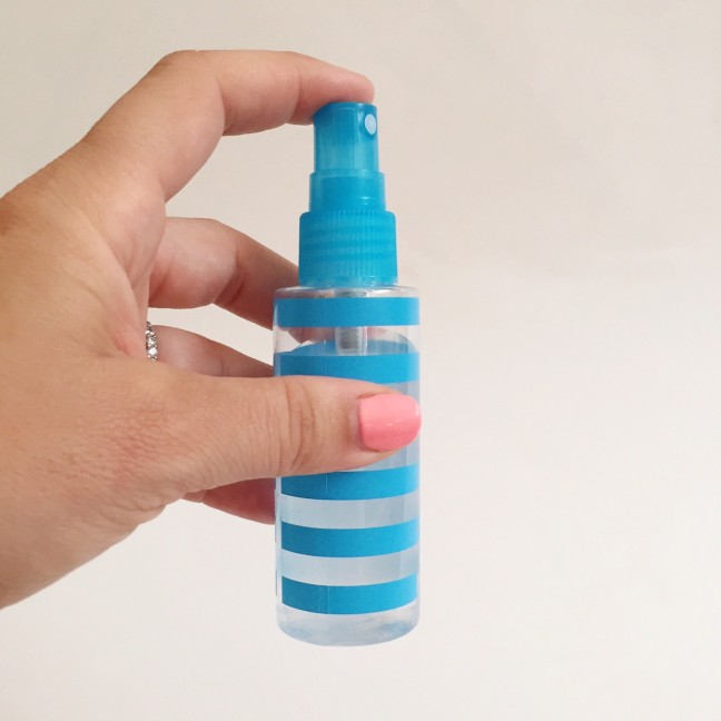 holding small spray bottle