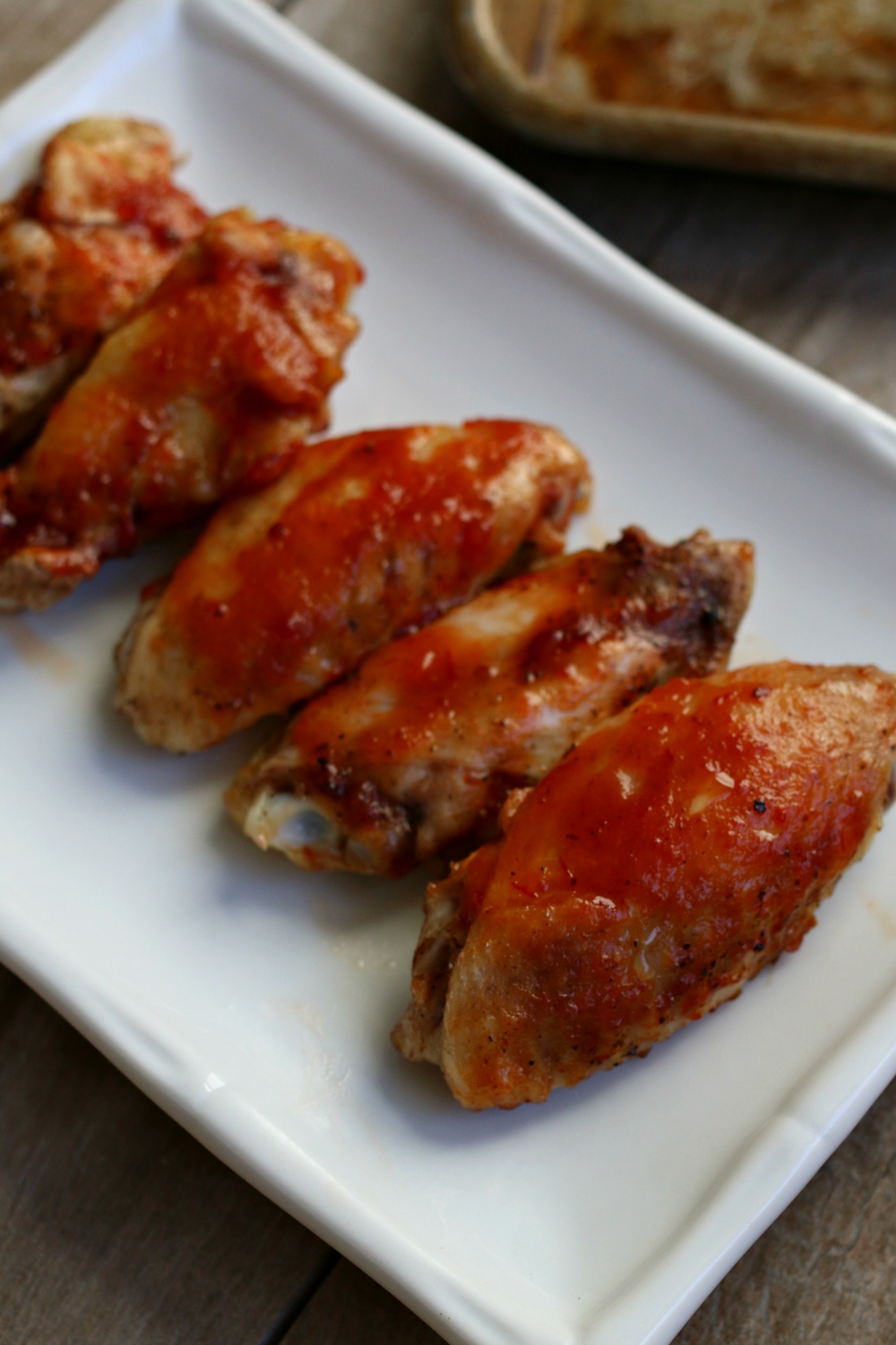barbecue chicken wings on white plate