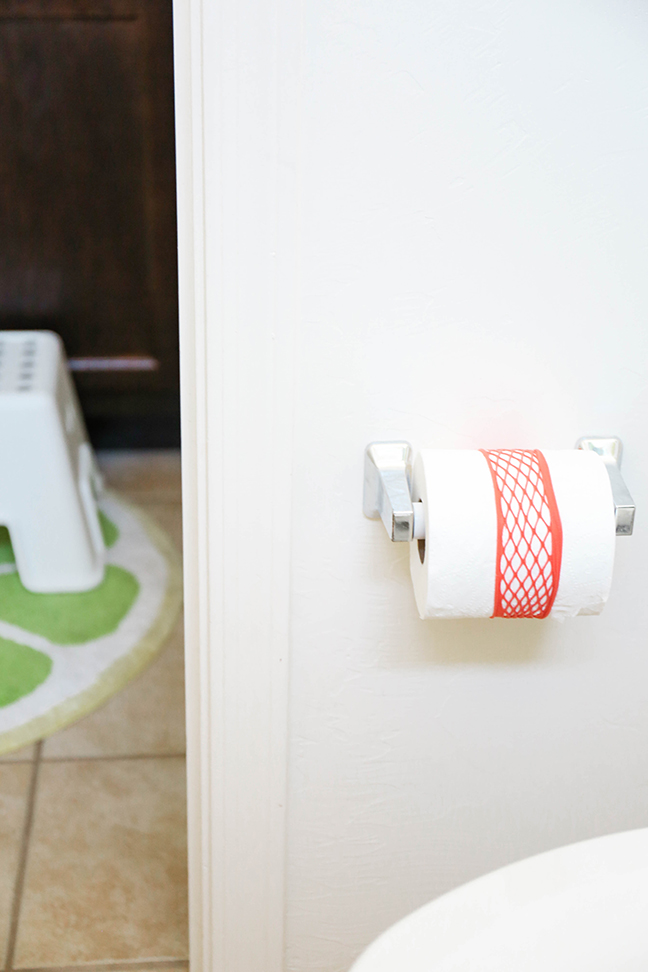 Keep bathrooms clean and tidy by placing a headband around the toilet paper roll \\ Toddler Proofing Tricks You've Never Heard of Before