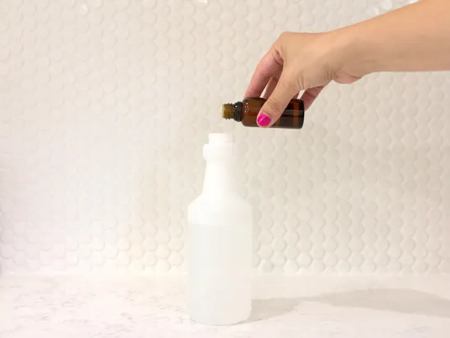 hand-pouring-essential-oils-into-spray-bottle