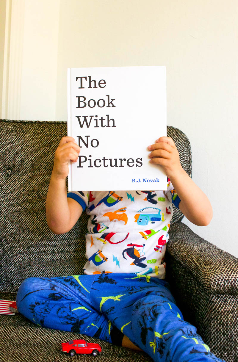 kid holding book with no pictures