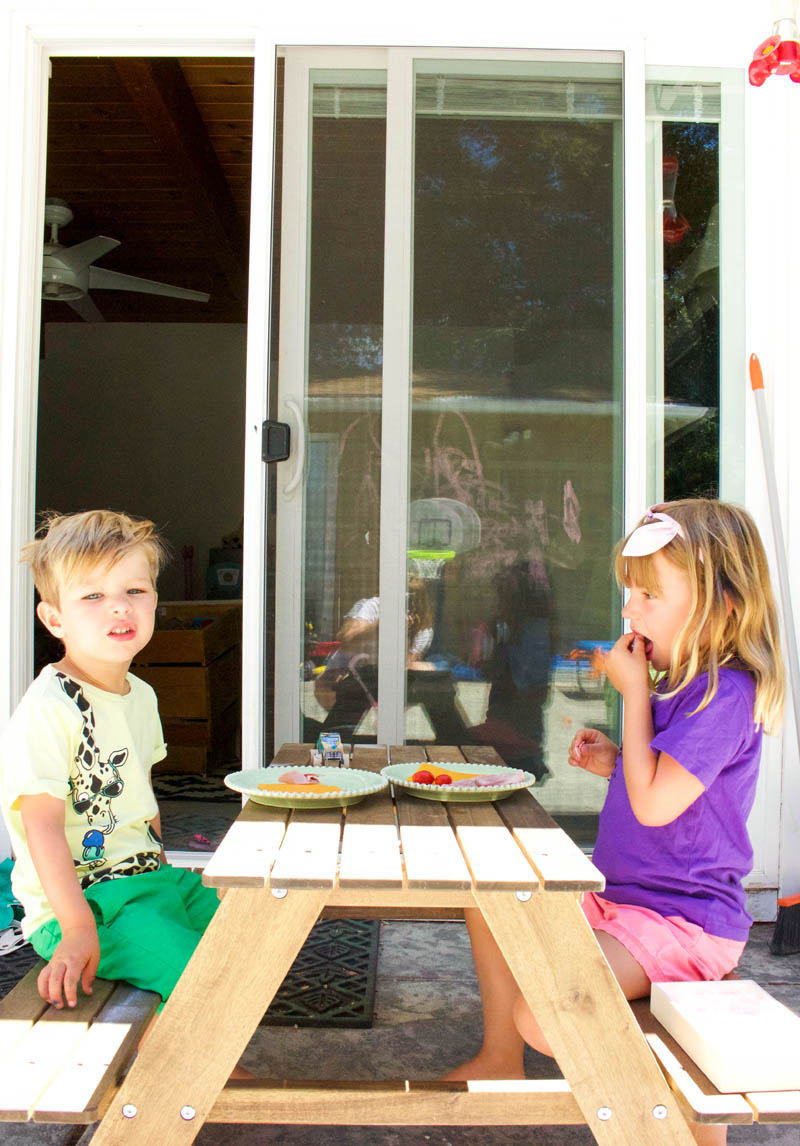 kids eating dinner at picnic table