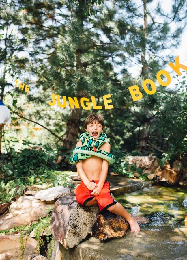 the-jungle-book-boy-wrapped-in-a-snake-outdoors