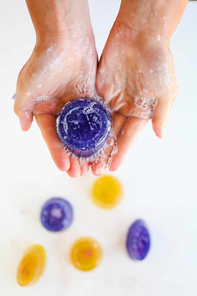 hands holding purple soap