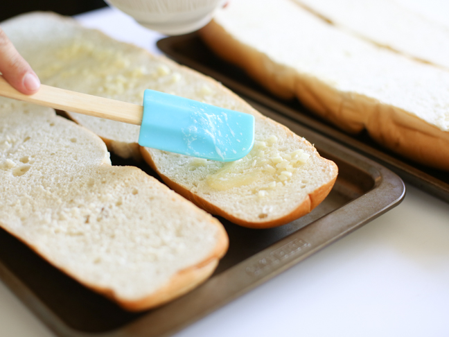 spreading garlic butter blue spatula