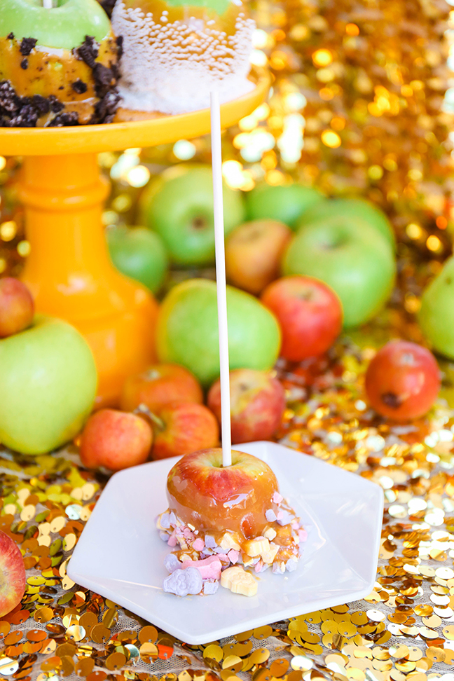 caramel apple dipped in sweetarts on white plate