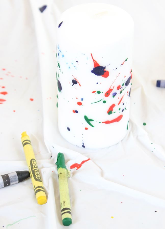 splattered crayons on white candle