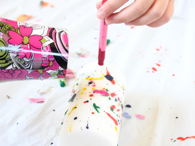 splattering melted crayon onto white candle