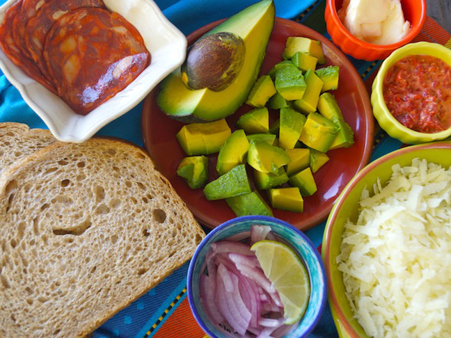 avocado-green-red-grated cheese-sliced onion-bread